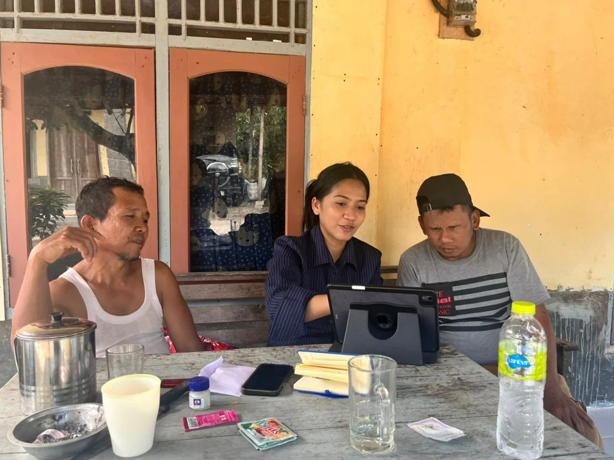 Adelia discussing the design with village residents